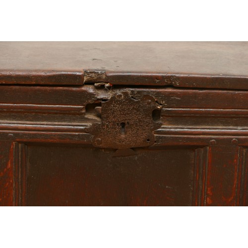 482 - An 18th century oak coffer, having two plank hinged top over three panel front, with arcaded frieze ... 