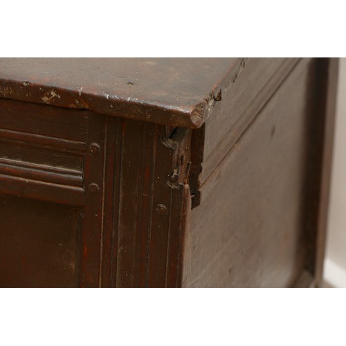 482 - An 18th century oak coffer, having two plank hinged top over three panel front, with arcaded frieze ... 