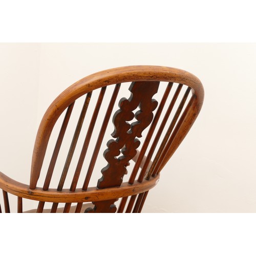 483 - A 19th century yew wood and elm Windsor chair, hoop stick back with pierced splat, saddle seat raise... 