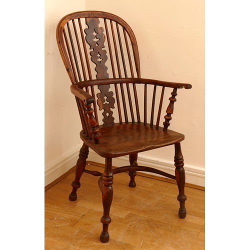 483 - A 19th century yew wood and elm Windsor chair, hoop stick back with pierced splat, saddle seat raise... 