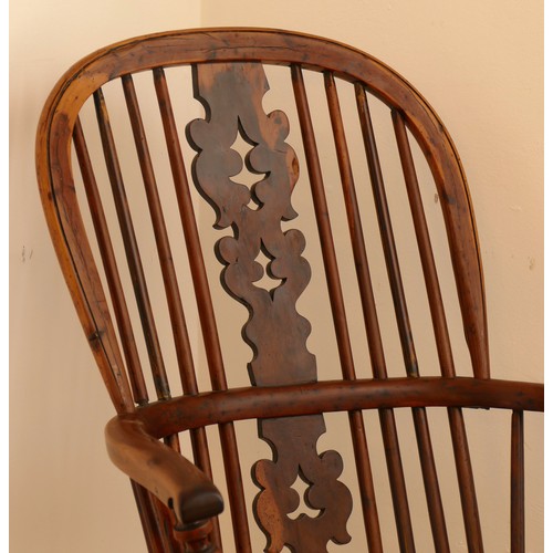 483 - A 19th century yew wood and elm Windsor chair, hoop stick back with pierced splat, saddle seat raise... 