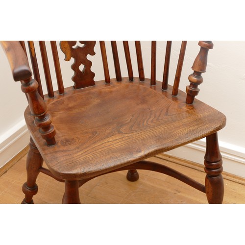 483 - A 19th century yew wood and elm Windsor chair, hoop stick back with pierced splat, saddle seat raise... 