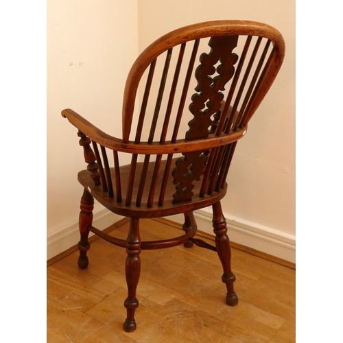 483 - A 19th century yew wood and elm Windsor chair, hoop stick back with pierced splat, saddle seat raise... 