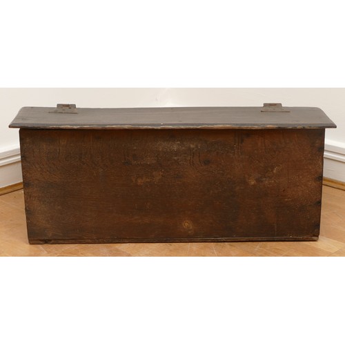 484 - A 17th century oak bible box, the rectangular iron hinged top over carved front with central wrought... 