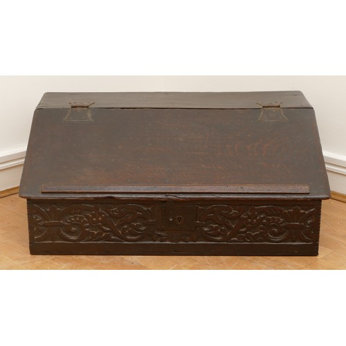 484 - A 17th century oak bible box, the rectangular iron hinged top over carved front with central wrought... 