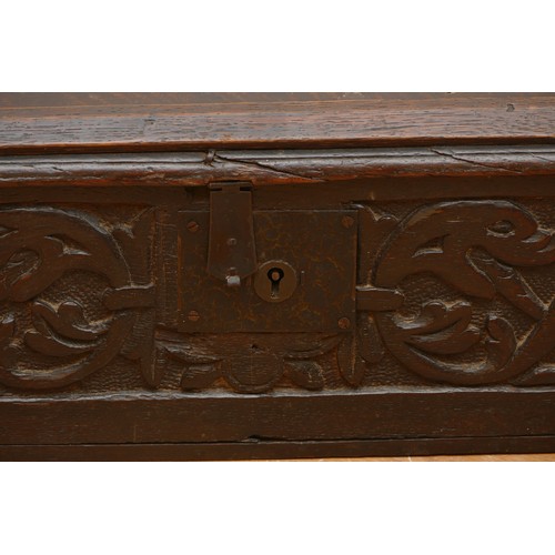 484 - A 17th century oak bible box, the rectangular iron hinged top over carved front with central wrought... 