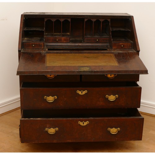 487 - A late 17th/early 18th century walnut bureau, veneered with cross banding, the overhanging slope wit... 