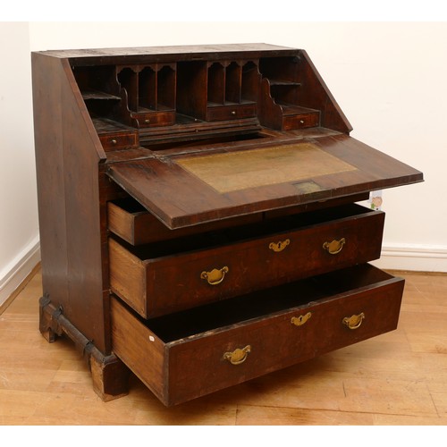 487 - A late 17th/early 18th century walnut bureau, veneered with cross banding, the overhanging slope wit... 