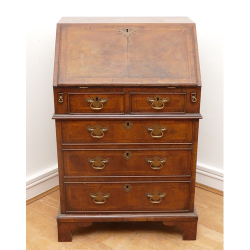 490 - A 19th century walnut bijou bureau, the drop leaf revealing fitted compartments, over two short and ... 