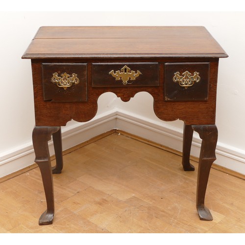 491 - A George III oak lowboy, having three frieze drawers and shaped apron, raised on cabriole legs with ... 