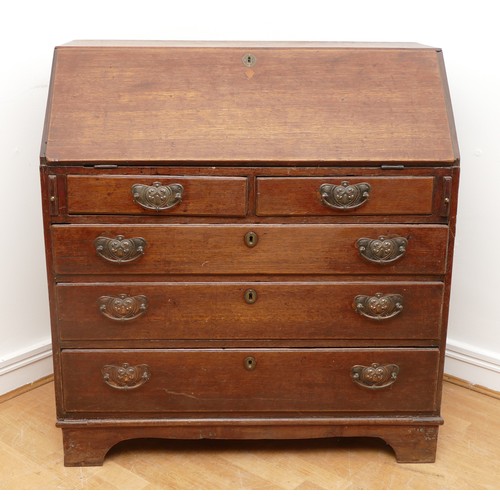 492 - A late 18th century oak bureau, the fall front opening to fitted interior, over two short and three ... 