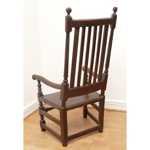 501 - A 17th century and later oak throne armchair, the slat back with inset solid seat, scroll arms on sq... 