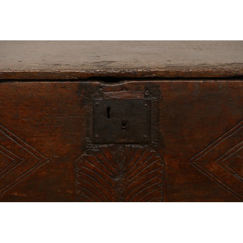 503 - A 17th century oak bible box, the sloped top with incised concentric roundels to the top above carve... 