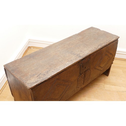 503 - A 17th century oak bible box, the sloped top with incised concentric roundels to the top above carve... 