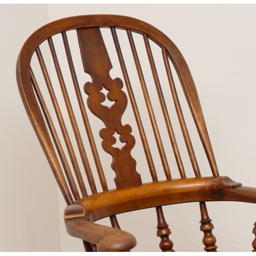 504 - A 19th century oak and elm armchair, with arcaded and pierced crest rail over a stick back and sides... 