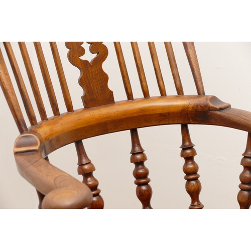 504 - A 19th century oak and elm armchair, with arcaded and pierced crest rail over a stick back and sides... 