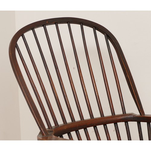 505 - A late 19th century pine windsor armchair, having spindle back and sides with scroll arms, saddle se... 