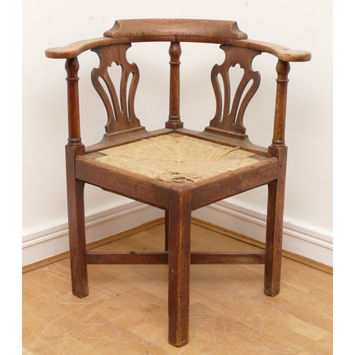 506 - A 19th century oak corner chair, with turned column upright supports, fret backrests and drop-in rus... 