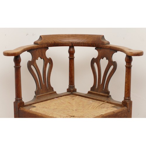 506 - A 19th century oak corner chair, with turned column upright supports, fret backrests and drop-in rus... 