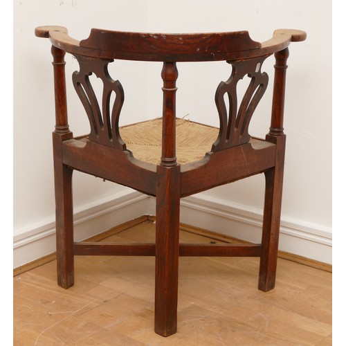 506 - A 19th century oak corner chair, with turned column upright supports, fret backrests and drop-in rus... 