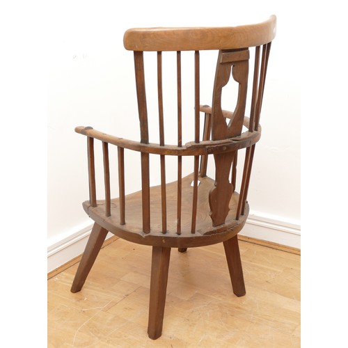 509 - An 18th Century primitive West Country Windsor elbow chair, the arch back with central shaped splat ... 