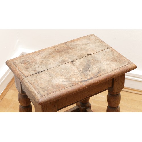 510 - A late 18th century oak jointed stool, the rectangular top with moulded edge, turned supports with l... 