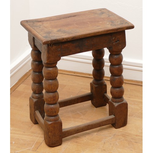 511 - A late 18th century oak jointed stool, the rectangular top with moulded edge, turned supports with l... 