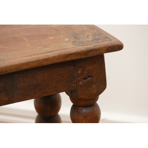 511 - A late 18th century oak jointed stool, the rectangular top with moulded edge, turned supports with l... 