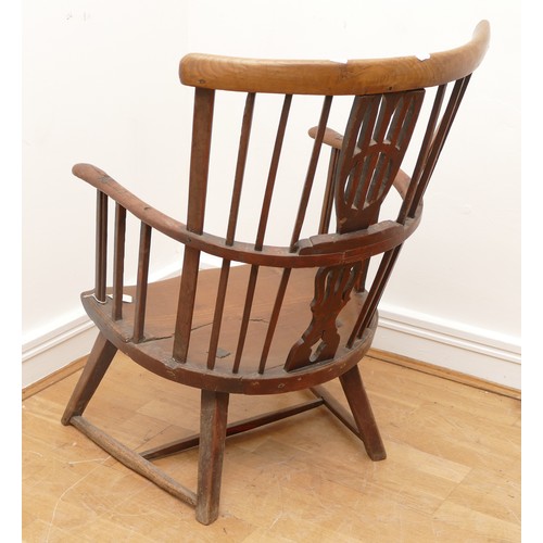 512 - An 18th Century ash primitive shawl back Windsor chair, West Country, the arched top rail above a sp... 