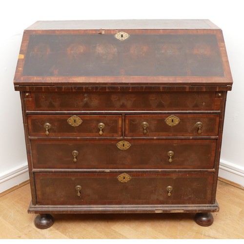 514 - A 17th century laburnum bureau, oyster veneered with walnut cross banding, the overhanging slope wit... 