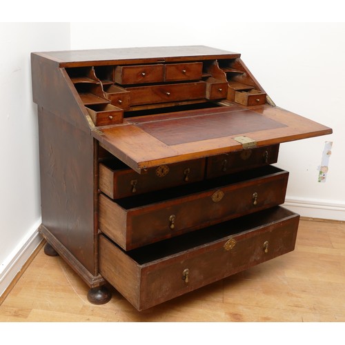 514 - A 17th century laburnum bureau, oyster veneered with walnut cross banding, the overhanging slope wit... 