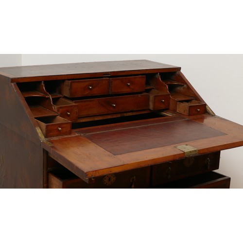 514 - A 17th century laburnum bureau, oyster veneered with walnut cross banding, the overhanging slope wit... 