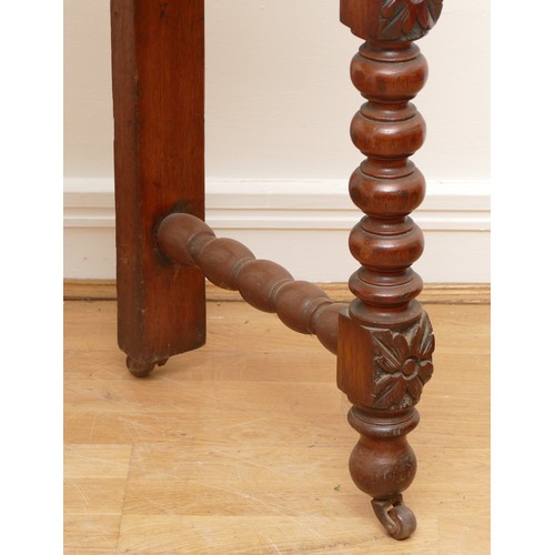 517 - A Victorian carved oak side table with scroll back rail over turned legs, 113 x 45 x 110cm.