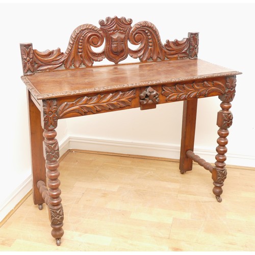 517 - A Victorian carved oak side table with scroll back rail over turned legs, 113 x 45 x 110cm.