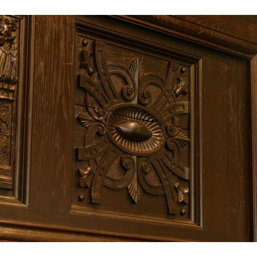 519 - A 19th century and later stained oak fireplace, with central carved panel depicting the baptism of C... 