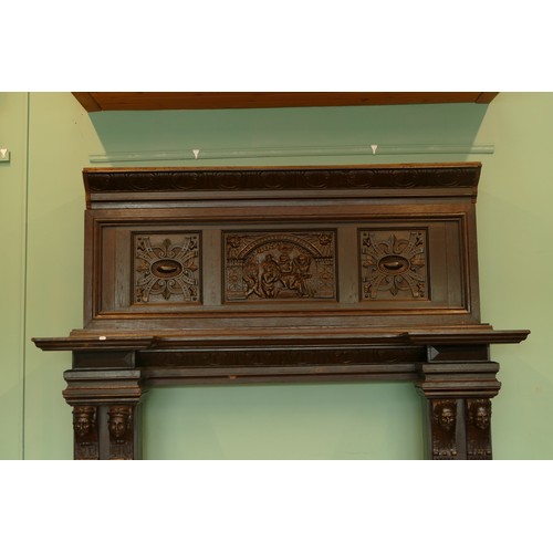 519 - A 19th century and later stained oak fireplace, with central carved panel depicting the baptism of C... 