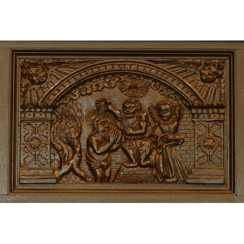 519 - A 19th century and later stained oak fireplace, with central carved panel depicting the baptism of C... 