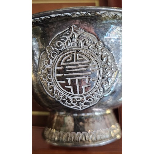 1 - A late 19th century Tibetan silver butter lamp bowl, unmarked, with four character panels, diameter1... 