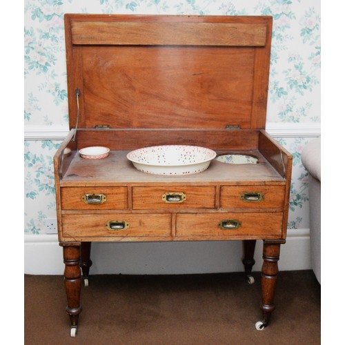 214 - A 19th century mahogany campaign washstand, the hinged lid opening to reveal a tin lined wash bowl, ... 