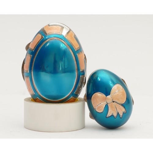 40 - Two unmarked silver and enamel eggs, with hinged covers, 6 and 4cm, 55gm