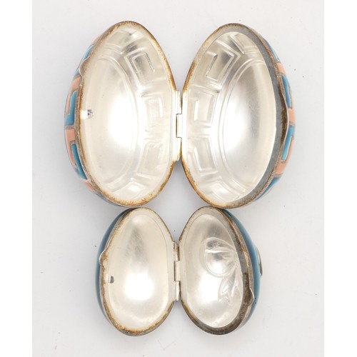 40 - Two unmarked silver and enamel eggs, with hinged covers, 6 and 4cm, 55gm