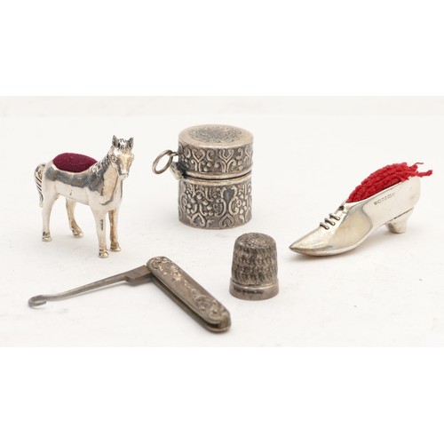 64 - A 925 silver horse pin cushion, a silver shoe pin cushion, London 1993 and three other items