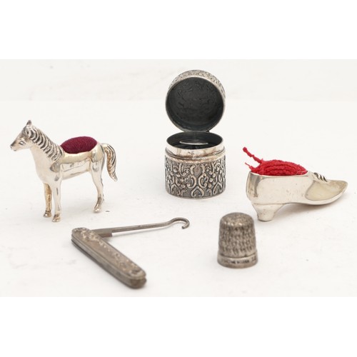 64 - A 925 silver horse pin cushion, a silver shoe pin cushion, London 1993 and three other items