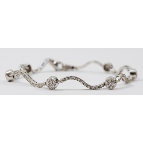 An Italian 18ct white gold, stamped 750, and brilliant cut diamond wavy link and ball bracelet, approximately 1.5cts, 18.5cm, 9.2gm