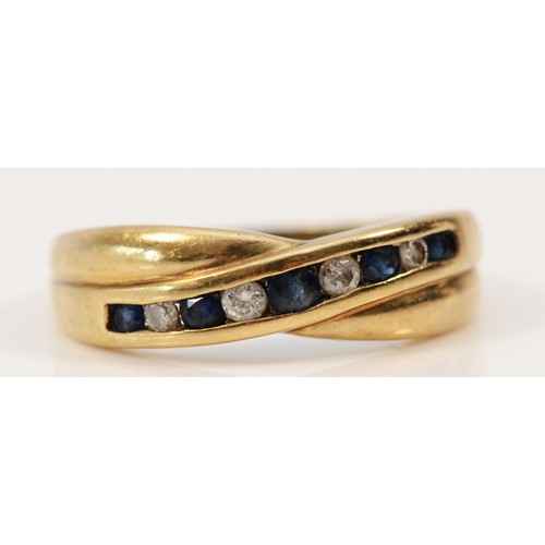 534 - A 9ct gold vintage sapphire and diamond cross over ring, K 1/2, 1.6g