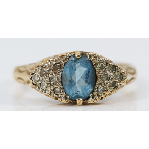 554 - A 9ct gold blue topaz and diamond dress ring with scroll patterned gallery, P, 3.1g