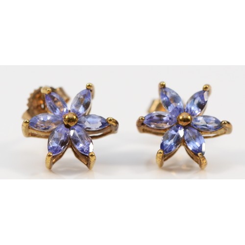 559 - A pair of 9ct gold tanzanite floral earrings with scroll backs, 10mm diameter, 1.6g