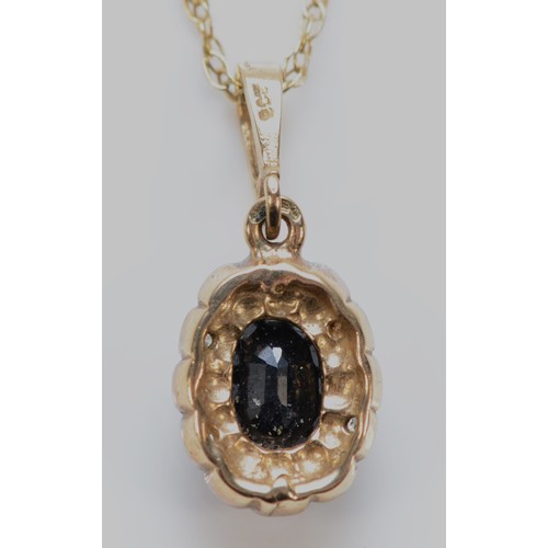 564 - A 9ct gold sapphire and diamond pendant with chain, 10mm, 1.8g