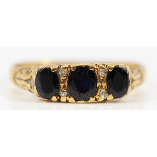 590 - A 9ct gold vintage sapphire and diamond dress ring with patterned gallery, Q, 2.9g