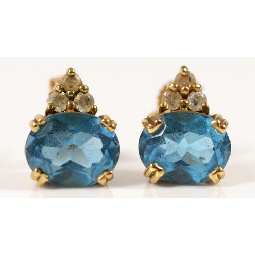 611 - A pair of 9ct gold blue topaz and diamond earrings with scroll backs, 10mm, 2.9g